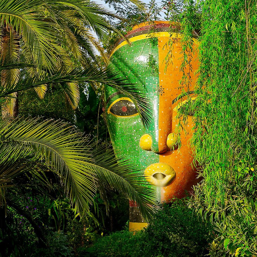 Giant green and orange mosaic face among palms at Anima Garden, on the Ourika road