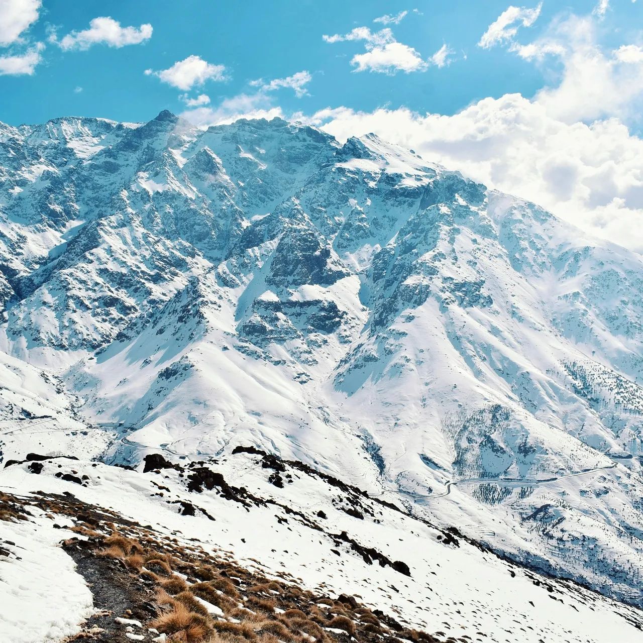 Snow-covered slopes of the High Atlas seen from Oukaïmeden under a blue sky